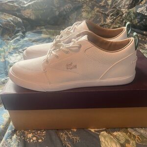 Lacoste white tennis shoes. Size 10. Never been worn.
